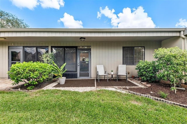 rear view of property featuring a lawn