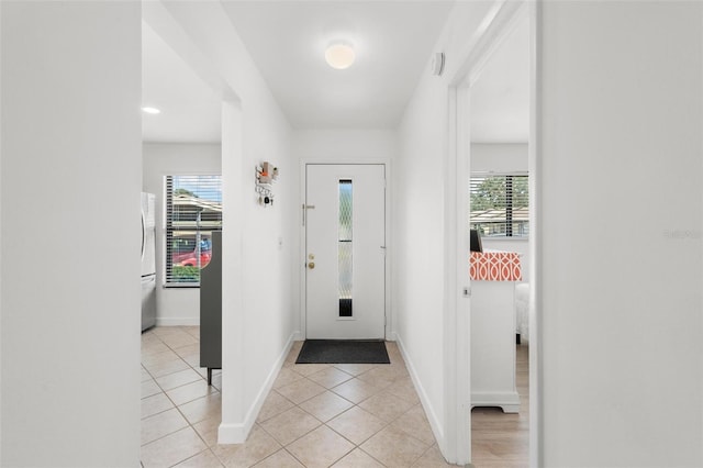 entryway featuring light tile patterned flooring and plenty of natural light