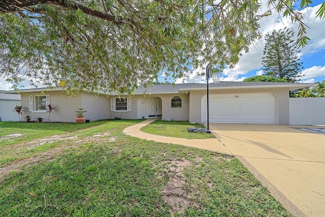 ranch-style house featuring a front yard and a garage