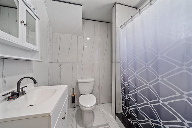 bathroom with a shower with shower curtain, tile walls, vanity, and toilet