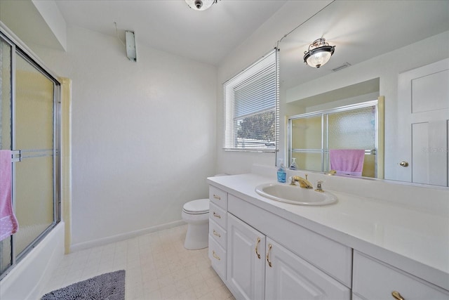 full bathroom featuring shower / bath combination with glass door, vanity, and toilet