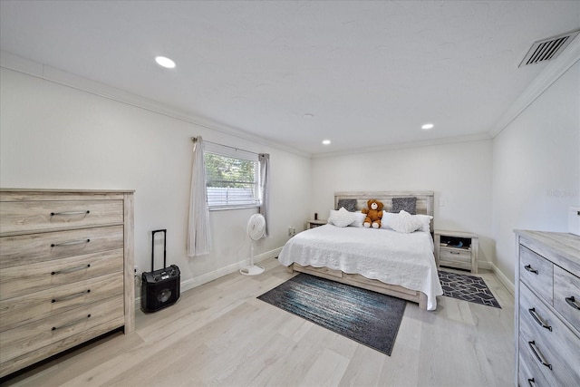 bedroom with light wood-type flooring and crown molding