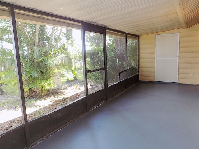 unfurnished sunroom featuring lofted ceiling