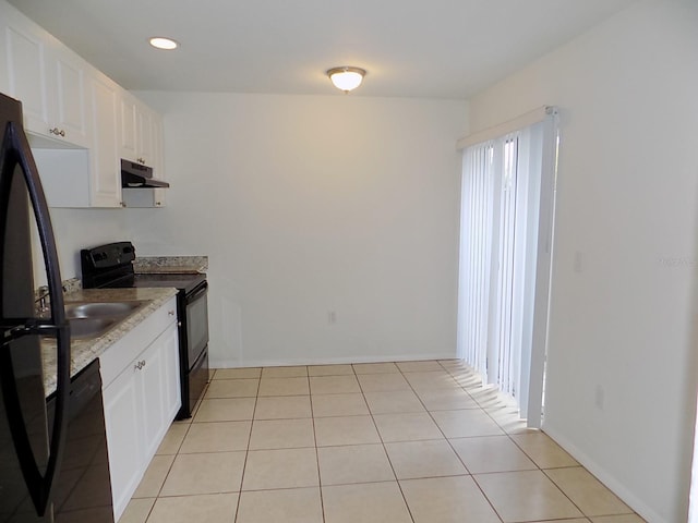 kitchen featuring white cabinets, black appliances, and light tile patterned floors