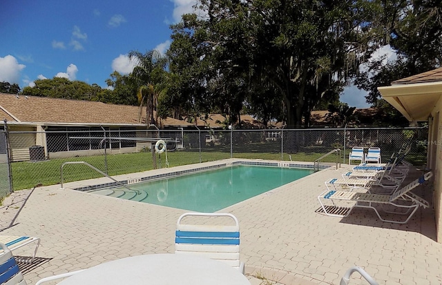 view of swimming pool featuring a yard and a patio area