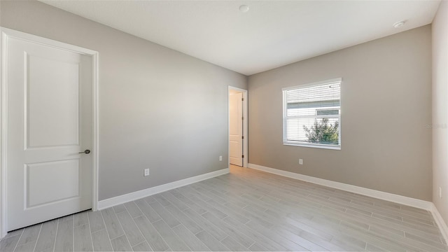 spare room with light hardwood / wood-style flooring