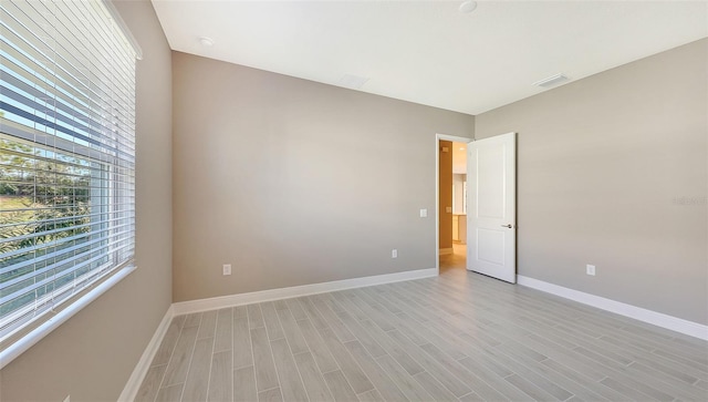 empty room with light hardwood / wood-style flooring