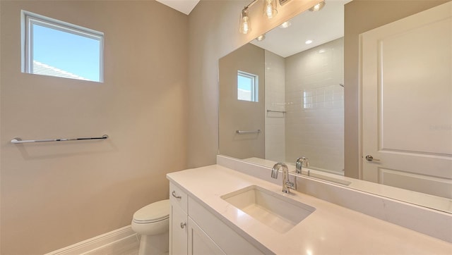 bathroom featuring walk in shower, a wealth of natural light, vanity, and toilet