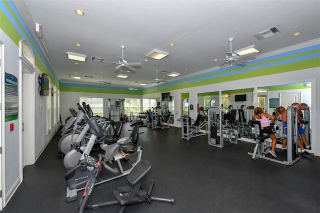 gym with ceiling fan and crown molding