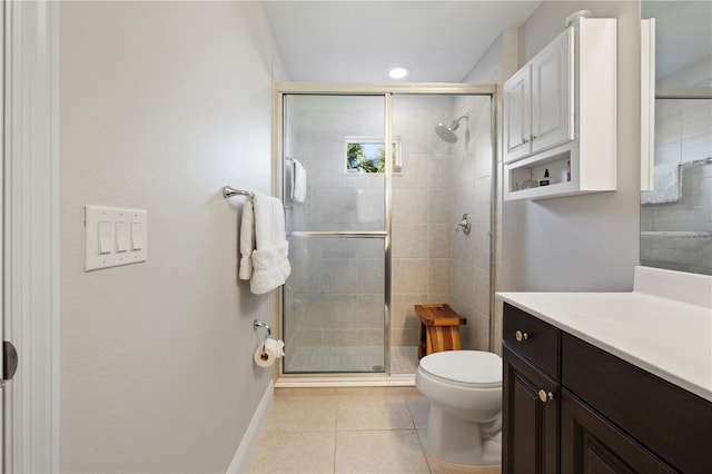 bathroom with toilet, tile patterned flooring, vanity, and walk in shower