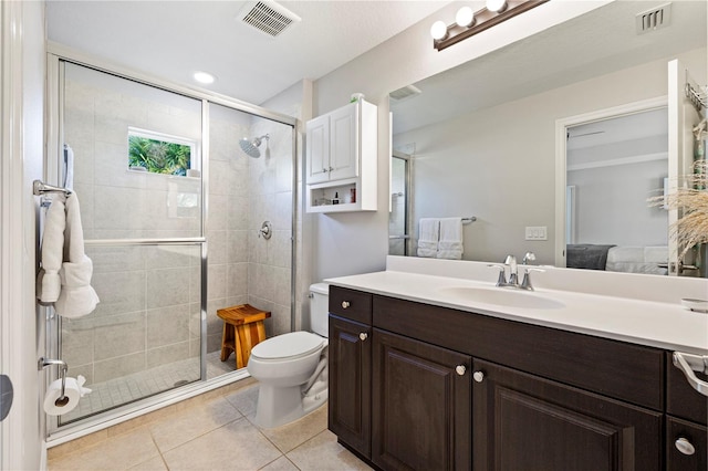 bathroom featuring tile patterned floors, vanity, toilet, and an enclosed shower