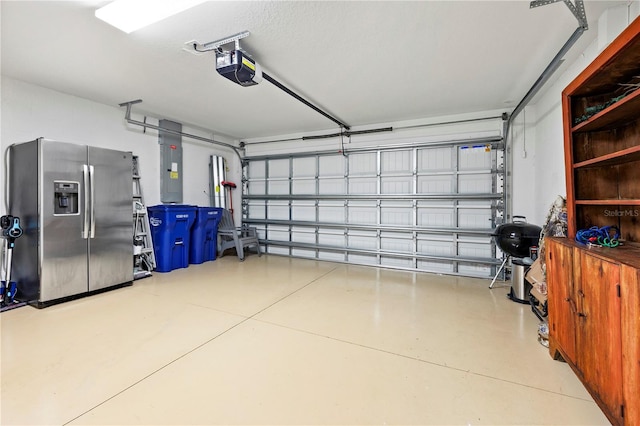 garage with stainless steel fridge, electric panel, and a garage door opener