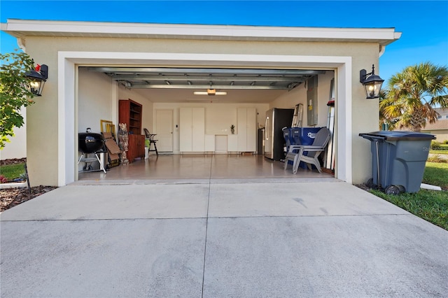 garage with stainless steel refrigerator