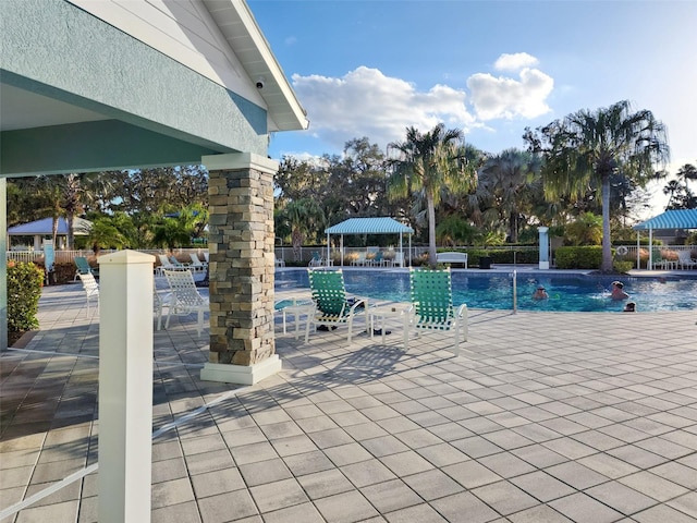 view of pool with pool water feature and a patio