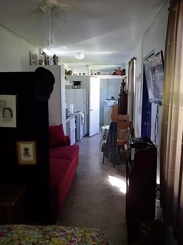 living room featuring washer / dryer and ceiling fan