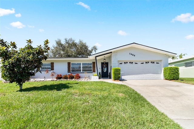 ranch-style house featuring a front lawn and a garage