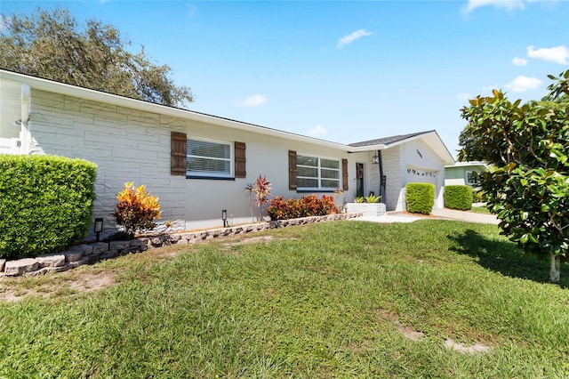 ranch-style home with a front yard and a garage