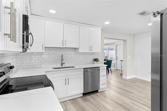 kitchen with white cabinetry, electric range, dishwasher, and sink