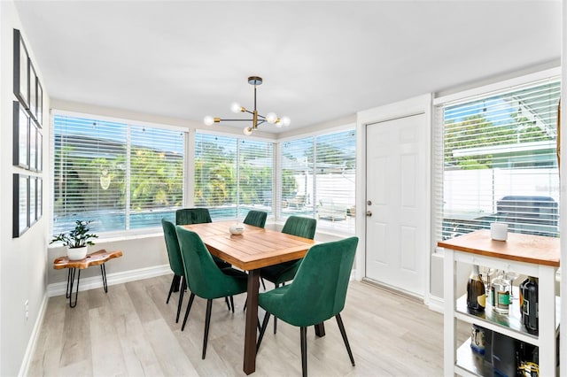 sunroom featuring an inviting chandelier