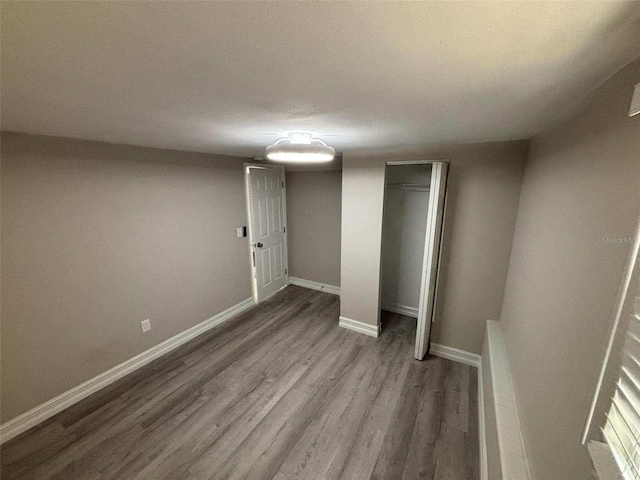 unfurnished bedroom featuring hardwood / wood-style floors and a closet