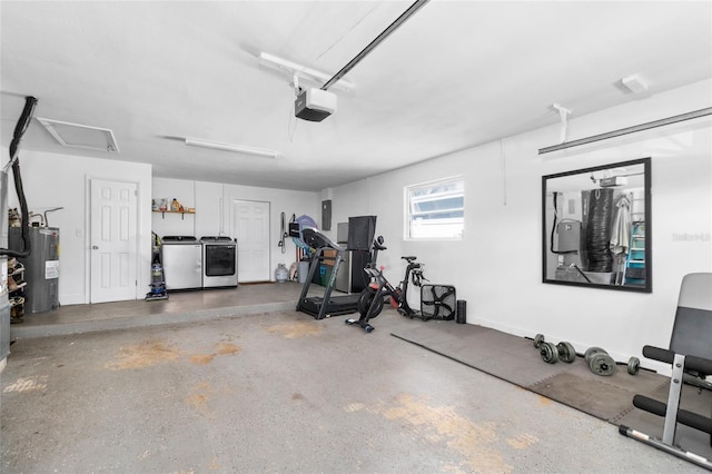 exercise area featuring electric water heater and washer and clothes dryer