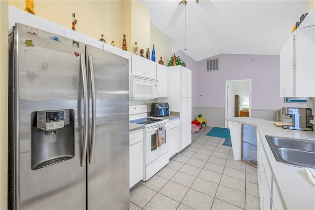 kitchen with ceiling fan, white cabinets, light tile patterned floors, white appliances, and vaulted ceiling