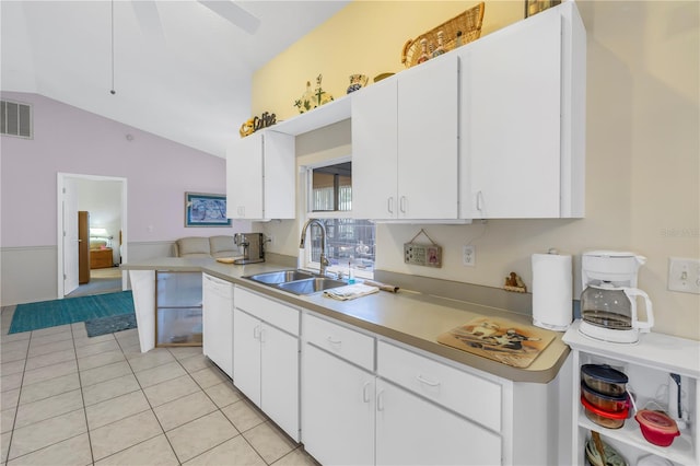 kitchen featuring vaulted ceiling, sink, white dishwasher, and white cabinets