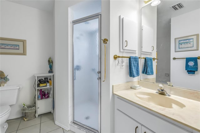 bathroom featuring vanity, tile patterned flooring, toilet, and a shower with door