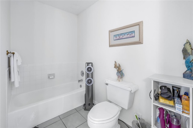 bathroom featuring tile patterned flooring, a bath, and toilet