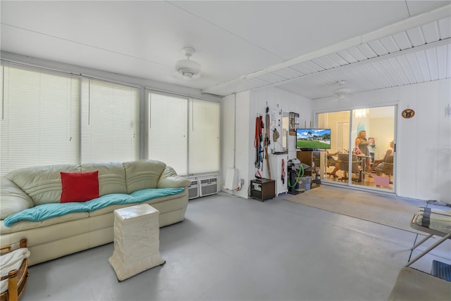 living room with concrete flooring and ceiling fan