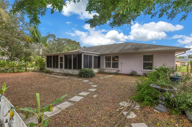 back of house with a sunroom