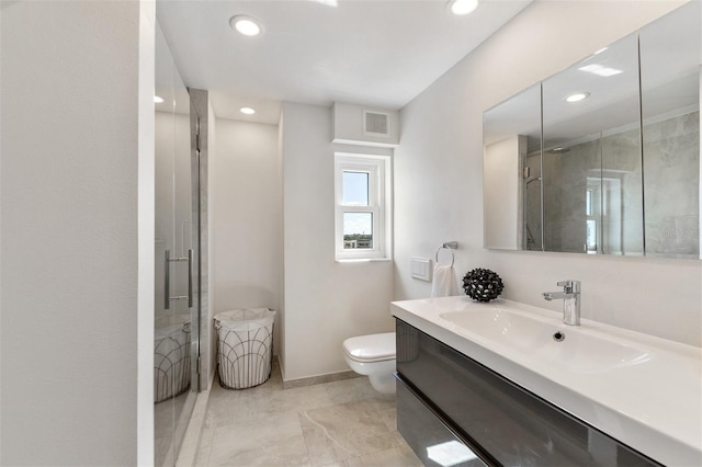 bathroom featuring vanity, toilet, and an enclosed shower