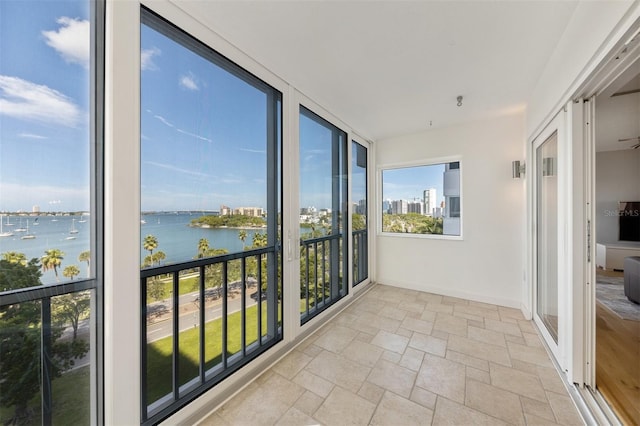 unfurnished sunroom featuring a water view