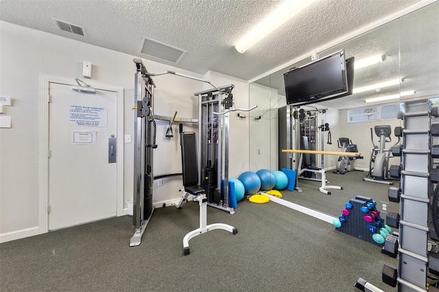 workout area with a textured ceiling