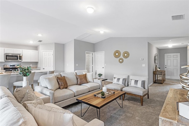 carpeted living room featuring lofted ceiling