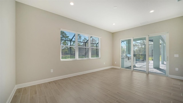 unfurnished room featuring light wood-type flooring and a wealth of natural light