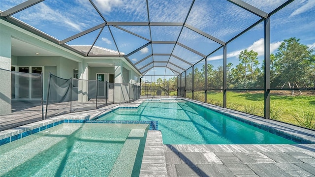 view of pool with glass enclosure and a patio