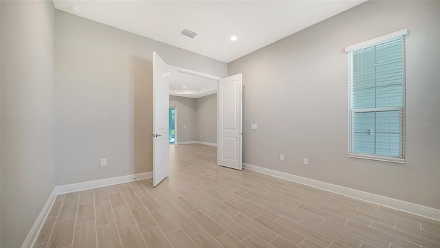 empty room featuring plenty of natural light and light wood-type flooring