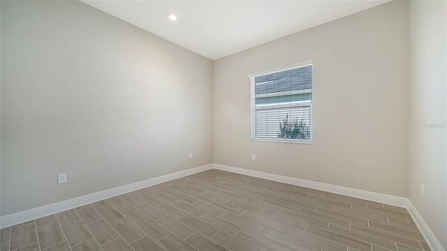 unfurnished room featuring vaulted ceiling and light hardwood / wood-style floors