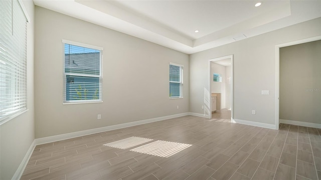 unfurnished bedroom featuring hardwood / wood-style floors and multiple windows