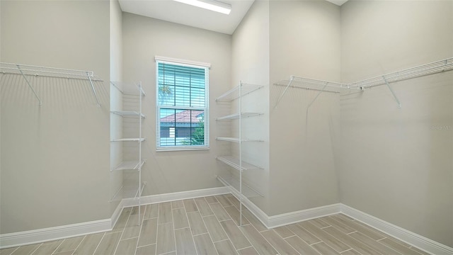 spacious closet with light hardwood / wood-style floors