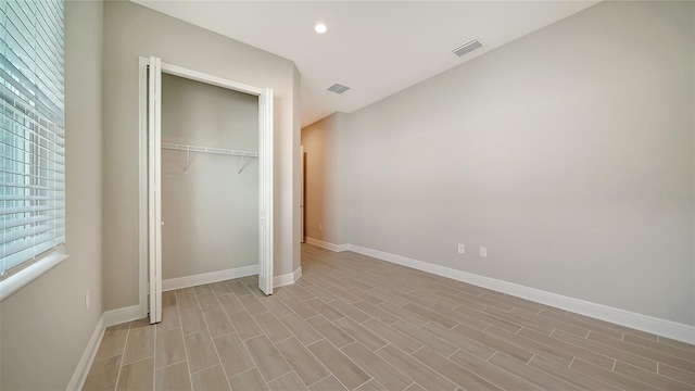 unfurnished bedroom with a closet and light hardwood / wood-style flooring