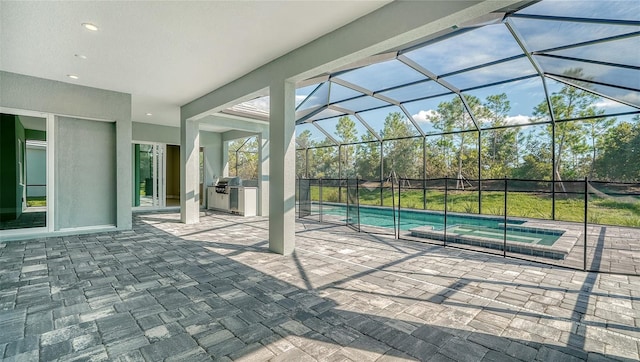 view of patio / terrace with a fenced in pool, an outdoor kitchen, and glass enclosure