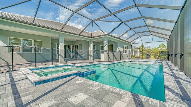 view of swimming pool featuring a lanai, an in ground hot tub, and a patio