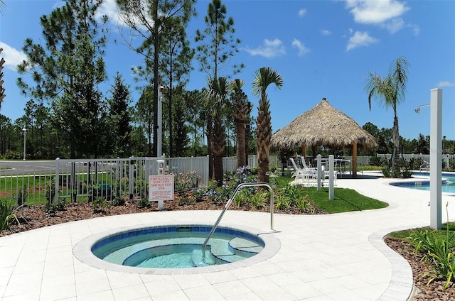 view of swimming pool featuring a gazebo and a hot tub