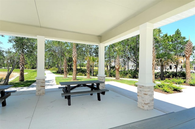 view of property's community featuring a patio and a lawn