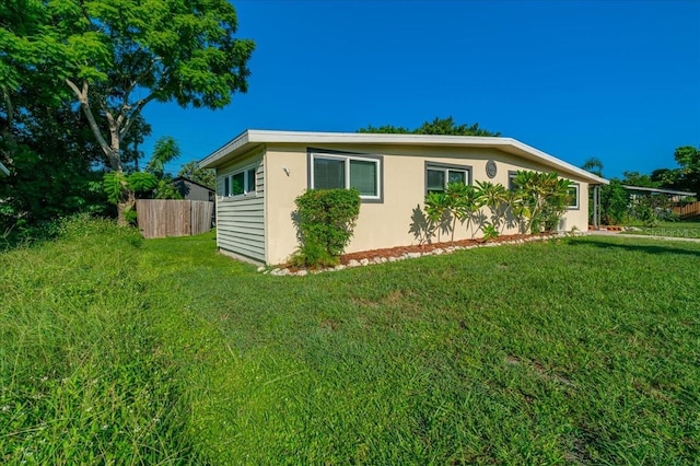 view of side of property featuring a yard