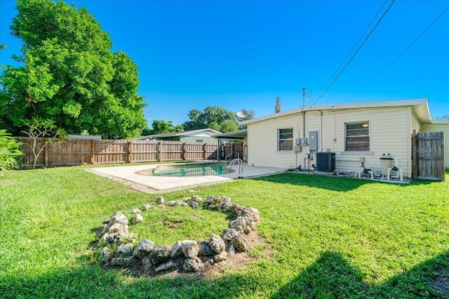 exterior space with a fenced in pool, a yard, a patio area, and central air condition unit