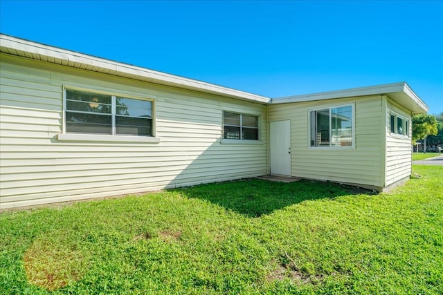 rear view of property with a lawn