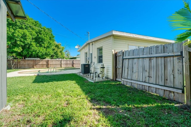 view of yard featuring a patio and central air condition unit